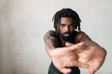 Image of african american sportsman doing exercise while working out