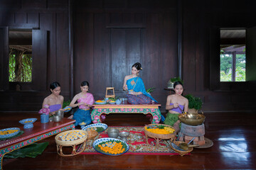 Beautiful group portrait Asian woman wearing Thai dress costume traditional according culture and tradition are making Thai desserts at ancient house Ayutthaya, Thailand