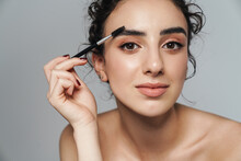 Image Of Half-naked Woman Using Cosmetic Brush For Her Eyebrows