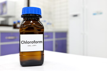 Wall Mural - Selective focus of chloroform or trichloromethane liquid chemical in glass amber bottle inside a chemistry laboratory with copy space.