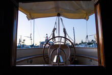 Boat Deck And Wheel From The Inside At Sunrise