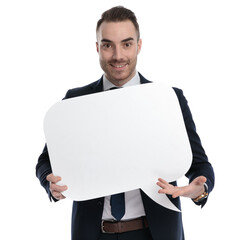 Poster - Positive businessman holding and presenting speech bubble