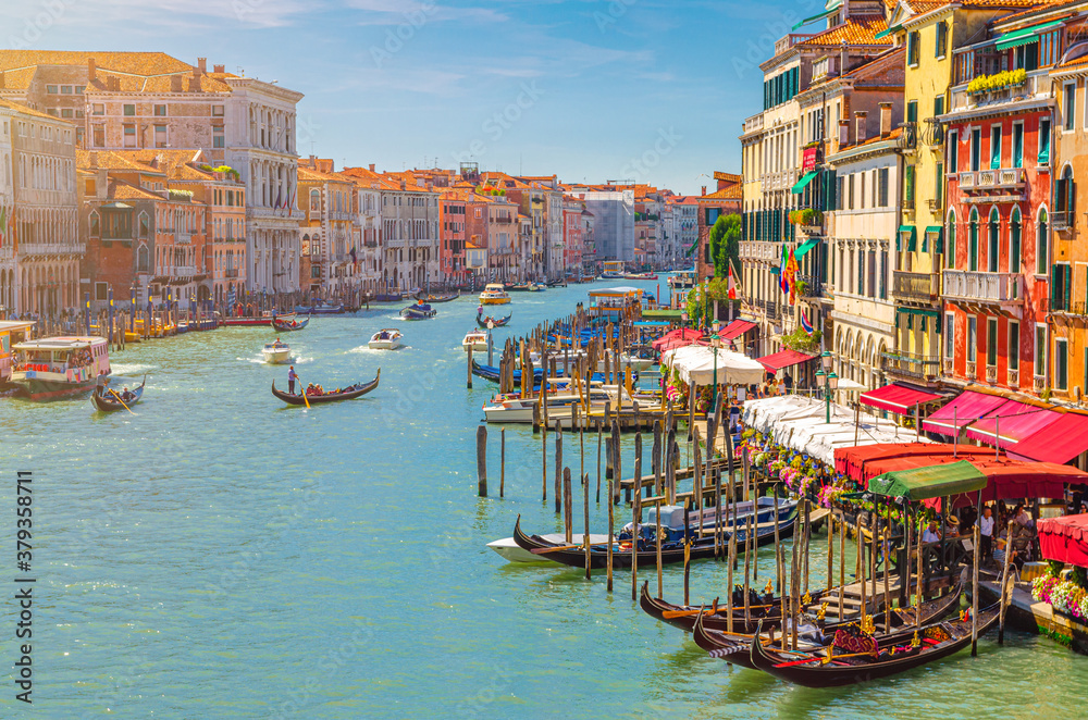 Venice cityscape with Grand Canal waterway. View from Rialto Bridge. Gondolas, boats, vaporettos docked and sailing Canal Grande. Venetian architecture colorful buildings. Veneto Region, Italy. - obrazy, fototapety, plakaty 
