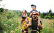 © Halfpoint - Family with small children hiking outdoors in summer nature.