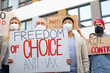© Halfpoint - People with placards and posters on public demonstration, no covid vaccine concept.