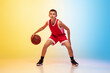 © master1305 - Strategy. Full length portrait of young basketball player in uniform on gradient studio background. Teenager confident posing with ball. Concept of sport, movement, healthy lifestyle, ad, action