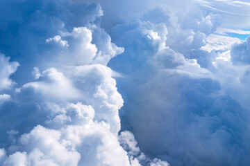 Wall Mural - Aerial view flying above clouds in the atmosphere, depicts heaven. space for text