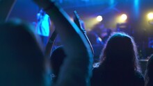 Crowd Of Fans Of The Musical Band Applauding In A Nightclub During Live Performance. Rock Concerts Where People Dancing And Adore Their Idols. Concept Of Parties And Night Lifestyle