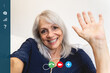 © Vane Nunes - Screen of a happy senior woman waving at camera while making a video call at home - Focus on the old lady face