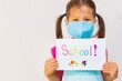 © globalmoments - Young student going to school, wearing a mask during covid epidemic. School health and safety.