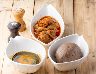 Amala and Ewedu with beef and assorted meat stew on a wooden background ready to eat