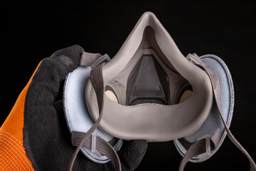 Dust mask in hand. Respiratory protection accessories.