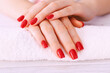 Manicure - nice manicured woman nails with red nail polish. Close up