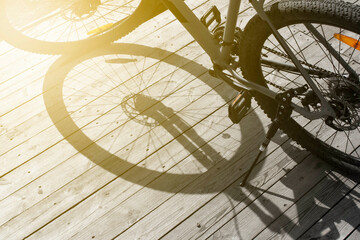  bike shadow on old wood texture, front and background blurred with bokeh effect