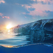Beautiful blue ocean surfing wave under sunset