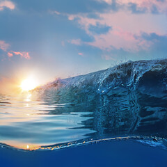 Fototapete - Beautiful blue ocean surfing wave under sunset