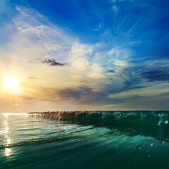 Fototapete - Beautiful sunset at the sea at south summer coast and colorful green blue wave line