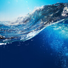 Fototapete - ocean-view seascape landscape big surfing ocean wave splitted by waterline with blue sky and sunlight