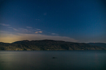 Wall Mural - starry sky seen from the shore of Okanagan lake at night british columbia Canada