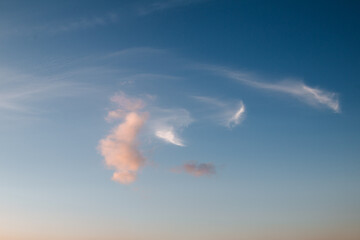 Wall Mural - the clouds in the sky are lit up by the rays of the setting sun