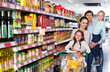 © JackF - Happy customers with children buying food in hypermarket and smiling
