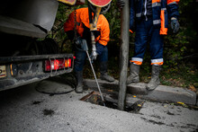 Cleaning Storm Drains From Debris, Clogged Drainage Systems Are Cleaned With A Pump And Water
