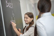 © zinkevych - Smiling cute girl writing on the blackboard