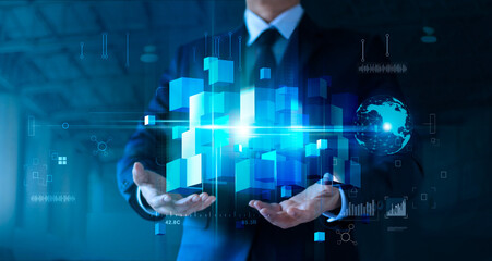 Leinwandbilder - Businessman holding blue cube box network connection on big data and block chain technology, symbolic of business, innovation, technology and security of information business.