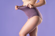 © staras - Woman in high-waisted corrective panties, female body in shapewear on purple background
