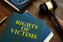 Rights Of Victims Book On The Wooden Surface.