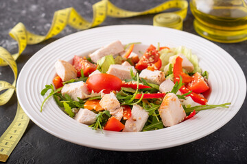 Wall Mural - Salad with chicken, cherry tomatoes, red pepper and arugula. Diet concept. Closeup