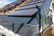 © Filip Olejowski - laying tiles on the roof of a single-family house