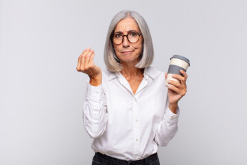 Wall Mural - middle age woman making capice or money gesture, telling you to pay your debts! coffee concept