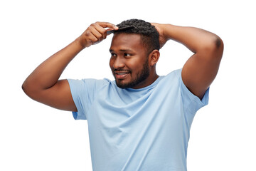 Wall Mural - beauty, grooming and hairstyling concept - happy smiling african american man brushing hair with comb over white background