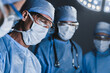 © InsideCreativeHouse - Concentrated surgeons operating patient in operating theatre. Healthcare workers concept.