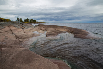 Wall Mural - Karelia. Russia. Skaters of Lake Ladoga. Stones on the coast. Northern nature of Russia. Single tours to Karelia. Nature of Russian Federation. Rest on Ladoga. A trip to Karelia. Panorama