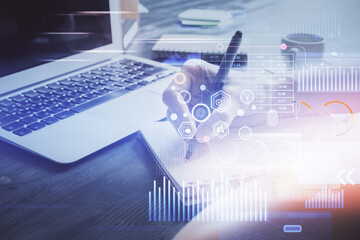 Multi exposure of writing hands on background with data solution hologram. Technology concept.