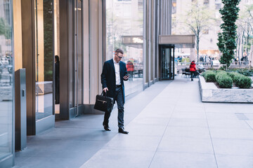 businessman coming out from office building