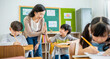 © paulaphoto - Pupil boy hi five with teacher in classroom at elementary school. Student boy studying in primary school. Children writing notes in classroom. Education knowledge, successful teamwork concept