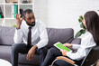 © LIGHTFIELD STUDIOS - selective focus of worried african american patient talking to brunette psychologist holding digital tablet with green screen