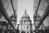 Fototapeta Londyn - Black and white photo of Saint Paul Cathedral reflected in modern glass walls in City of London, England