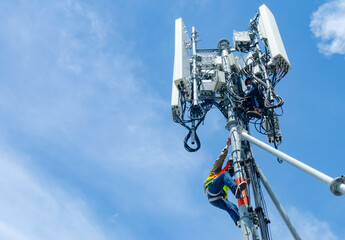 technician working on high telecommunication tower,worker wear Personal Protection Equipment for working high risk work,inspect and maintenance equipment on high tower.