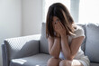 © Basicdog - Teenager Asian girl with depression sitting alone on the sofa in the room.