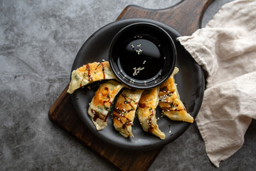 Wall Mural - Fried potstickers with balsamic glaze covered in seeds and chives