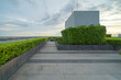© tampatra - Sky garden on private rooftop of condominium or hotel, high rise architecture building with tree, grass field, and blue sky.