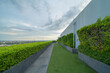 © tampatra - Sky garden on private rooftop of condominium or hotel, high rise architecture building with tree, grass field, and blue sky.