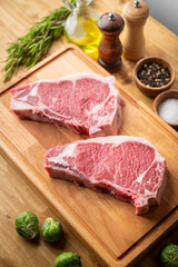 Wall Mural - raw steak meat on cutting board in bright kitchen