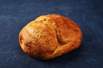 Bakery - gold rustic crusty loaves of bread and buns on blue chalkboard background.