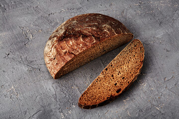 Bakery - gold rustic crusty loaves of bread and buns on grey chalkboard background.