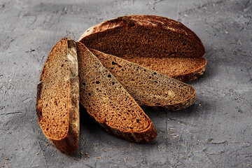 Bakery - gold rustic crusty loaves of bread and buns on grey chalkboard background.